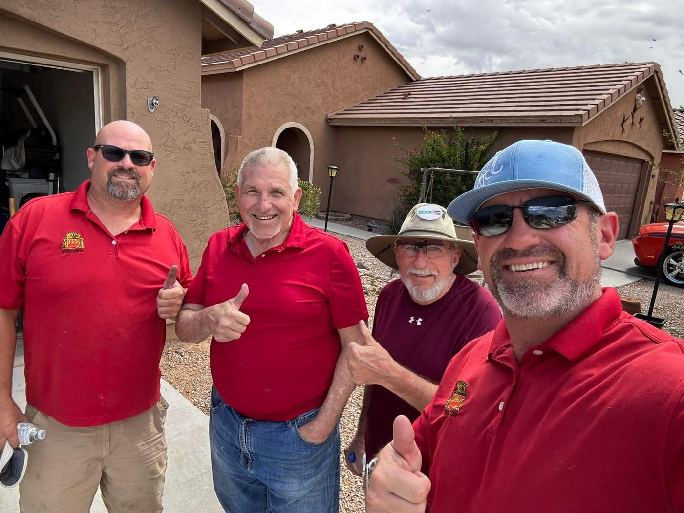 The Noble Refrigeration family team giving a thumbs up outside a customer's home