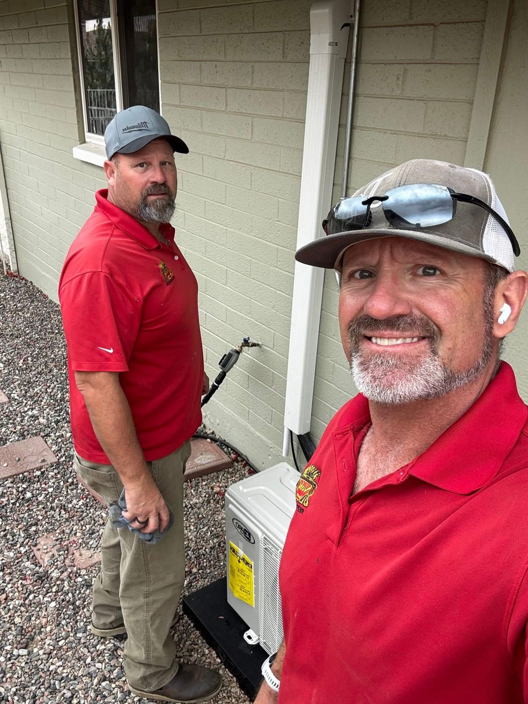 Two Noble technicians beside a newly installed mini-split