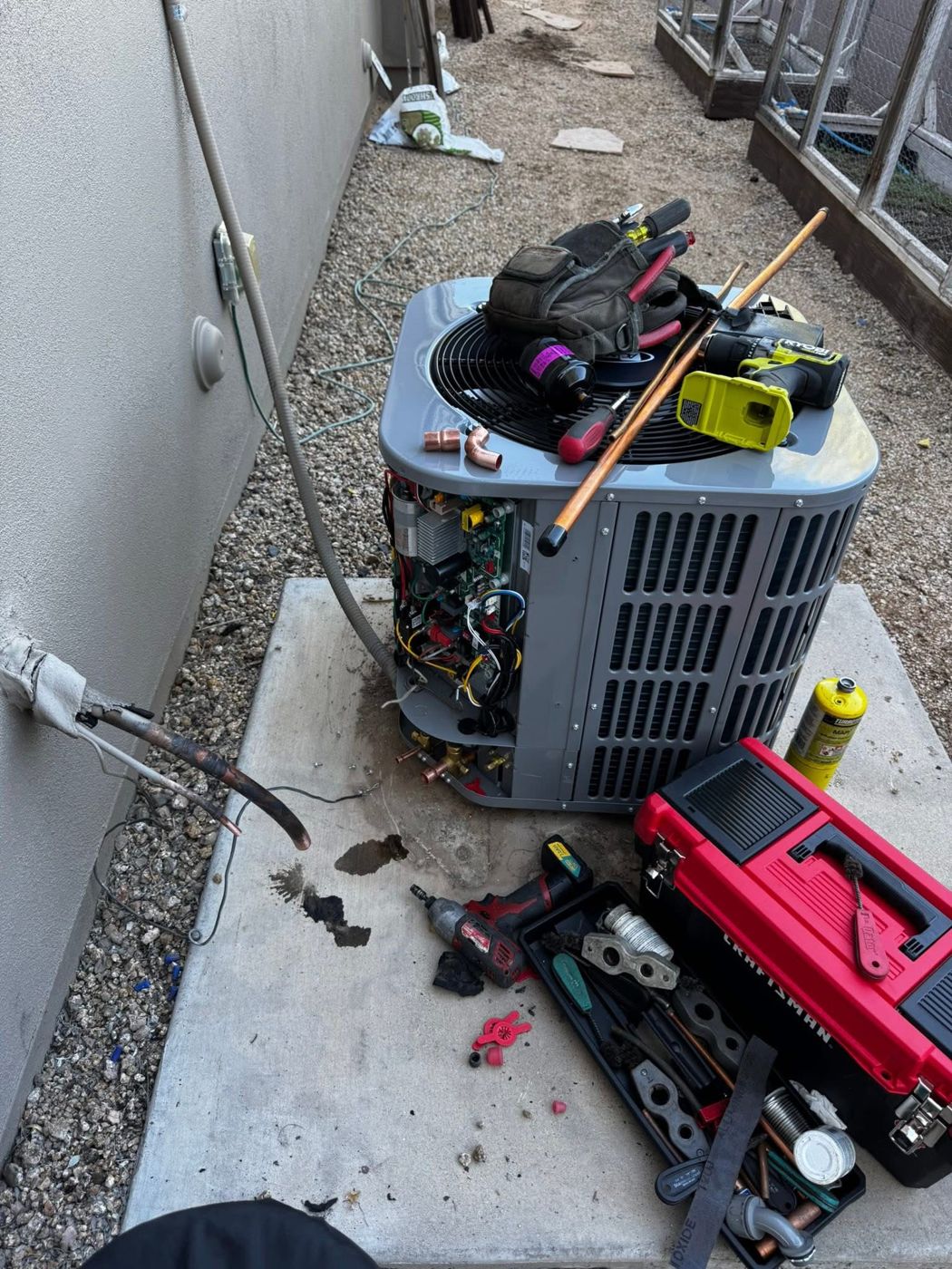 A new condenser mid-install with tools on top