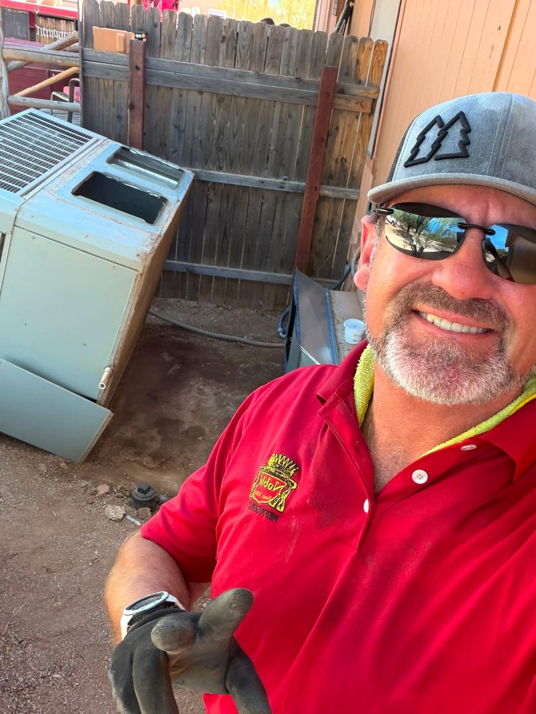 Noble technician with an old unit removed for replacement